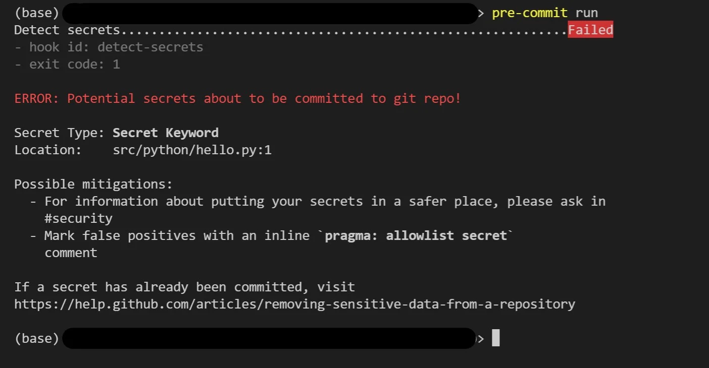 Real VS Code terminal output from a failed pre-commit run where the detect-secrets hook blocked a commit β the header shows 'Detect secrets........Failed', hook id: detect-secrets, exit code: 1, then 'ERROR: Potential secrets about to be committed to git repo!' with Secret Type: Secret Keyword and Location: src/python/hello.py:1, followed by mitigation guidance pointing developers to the #security channel or to mark false positives with an inline `pragma: allowlist secret` comment